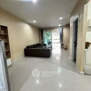 Spacious living room with modern decor and large windows for natural light.