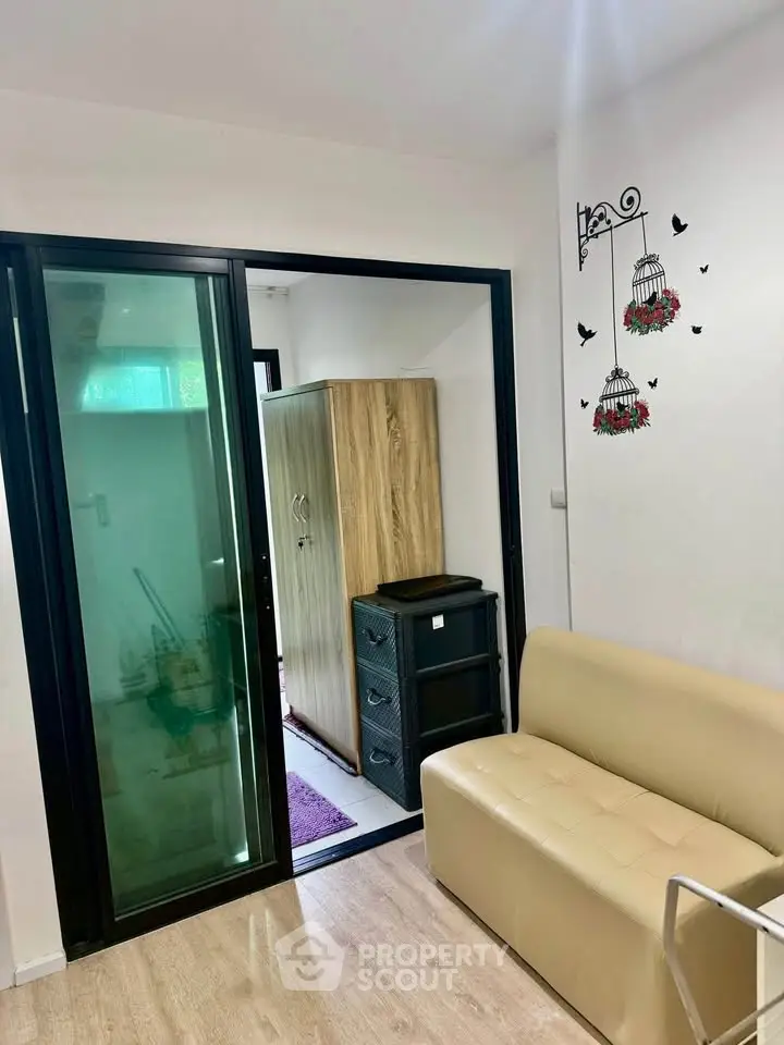 Cozy living space with sliding glass door and modern decor, perfect for urban living.