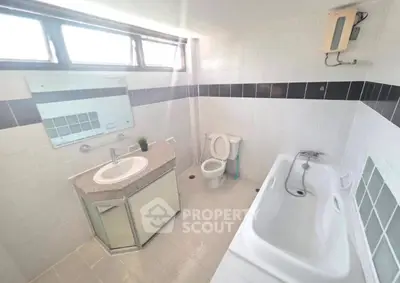 Bright and spacious bathroom with modern fixtures and bathtub