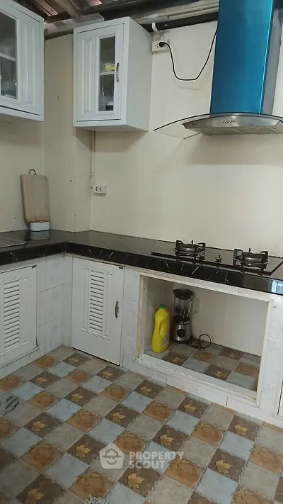 Charming kitchen with gas stove and modern cabinetry, perfect for culinary enthusiasts.
