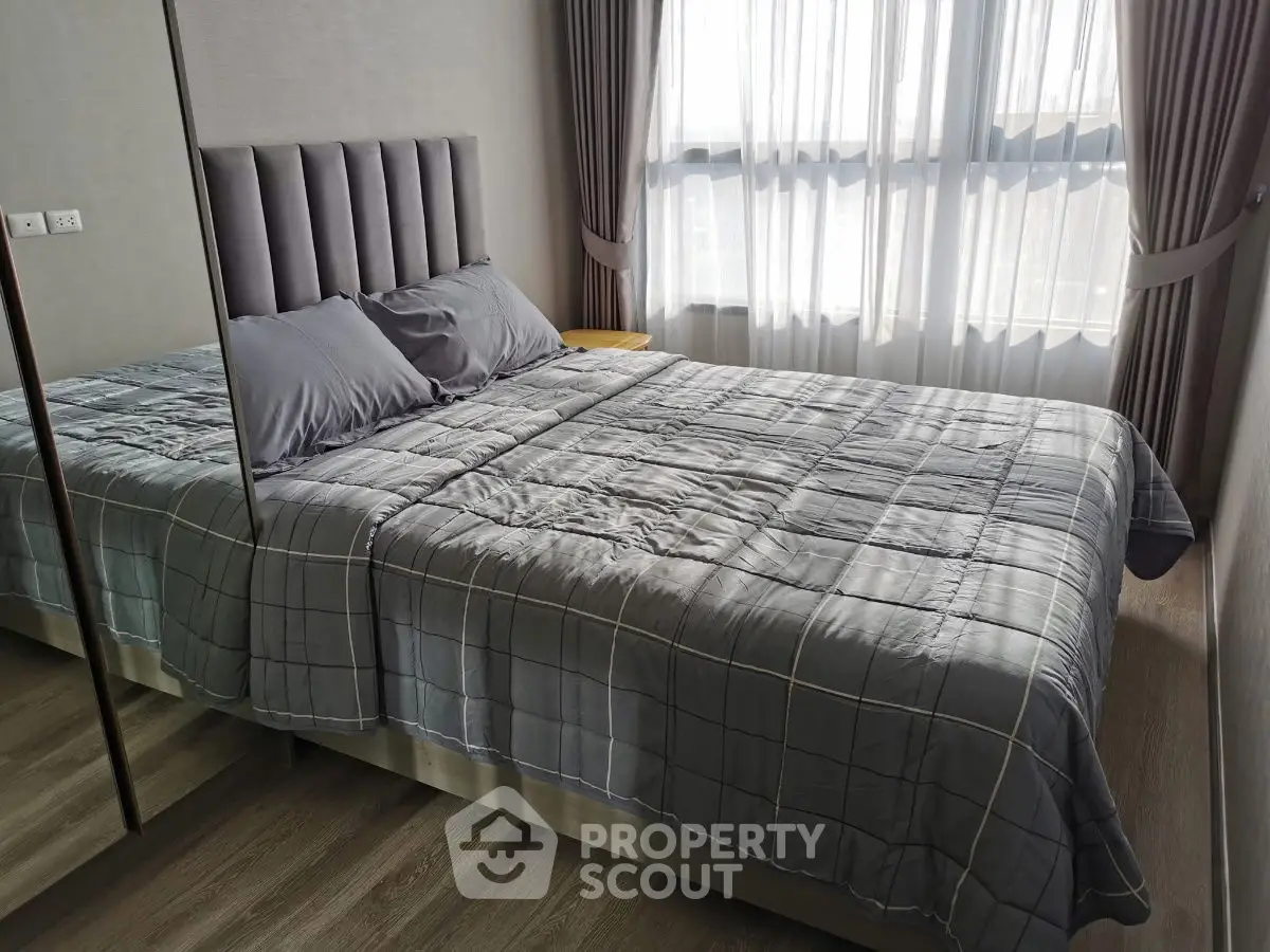 Modern bedroom with stylish decor and large window for natural light