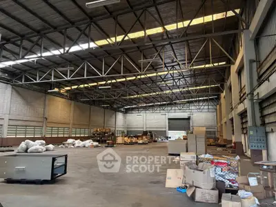 Spacious industrial warehouse with high ceilings and ample storage space.