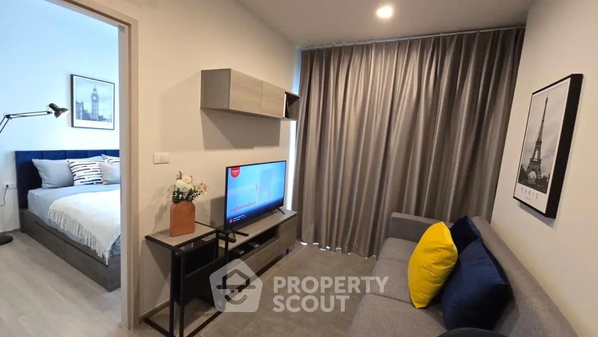 Modern living room with stylish decor and adjacent cozy bedroom