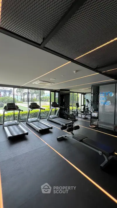Modern gym with state-of-the-art equipment and panoramic garden views.