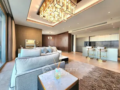 Luxurious open-plan living room with modern kitchen and elegant lighting