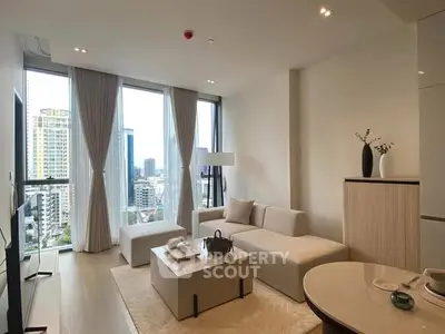 Modern living room with panoramic city view, elegant furnishings, and natural light.