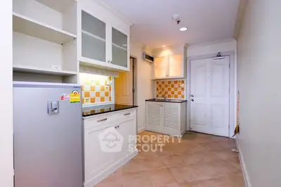 Charming kitchen with closed layout and modern appliances in cozy apartment