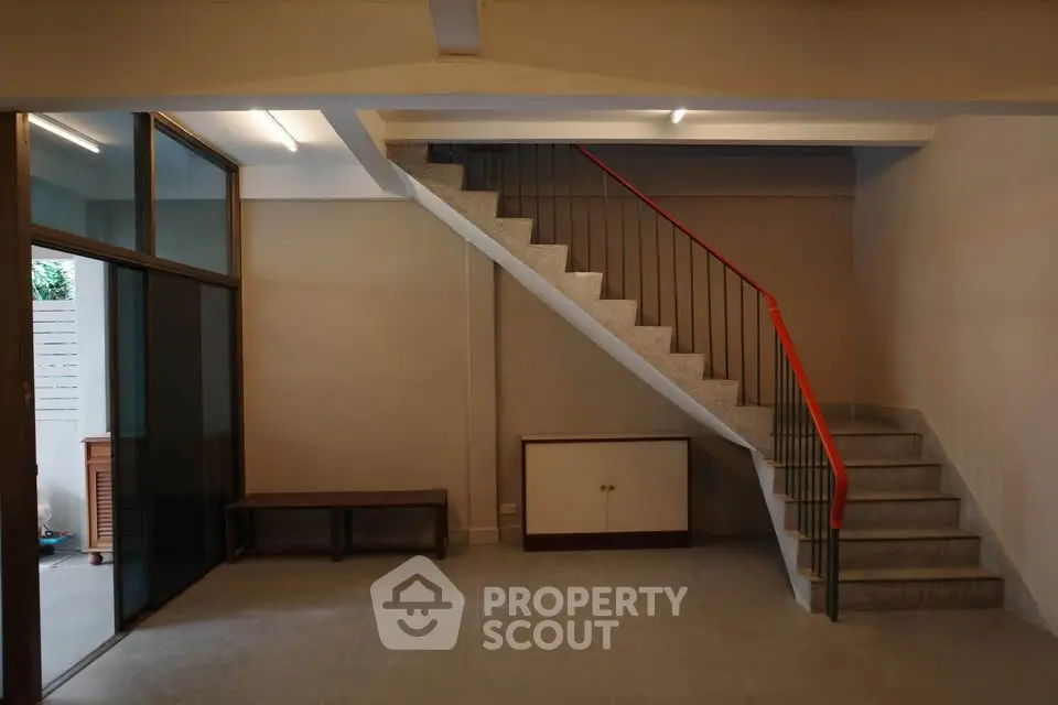 Spacious interior with modern staircase and large windows in a stylish home