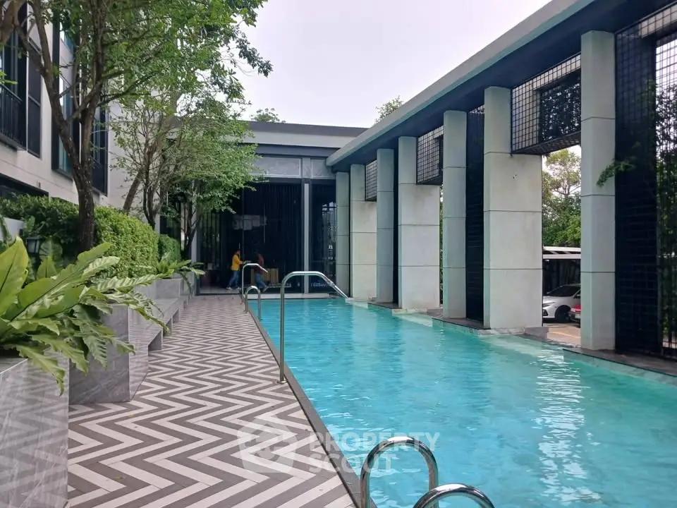 Luxurious modern pool area with stylish design and lush greenery