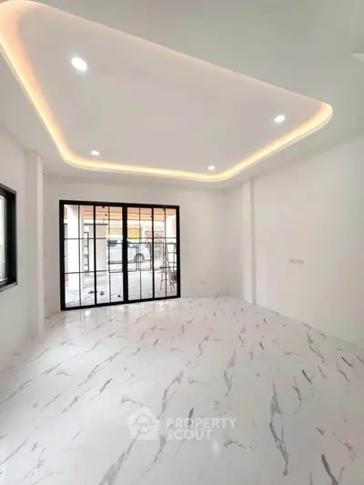 Spacious modern living room with marble flooring and recessed lighting