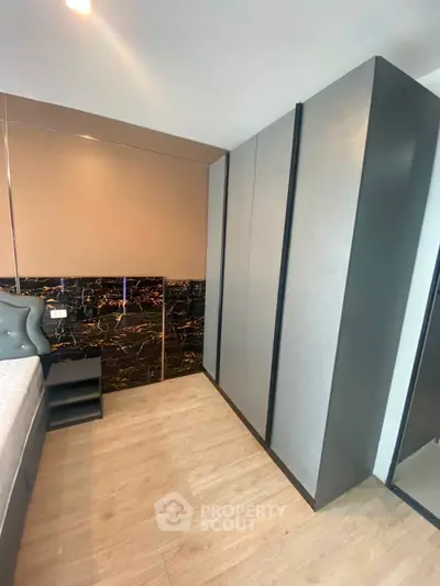 Modern bedroom with stylish wardrobe and elegant decor