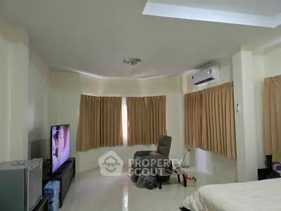 Spacious living room with modern furnishings and air conditioning, perfect for relaxation and entertainment.