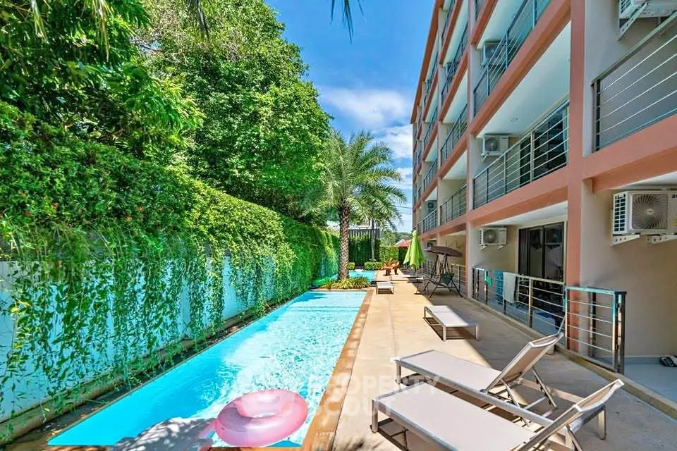 Luxurious apartment building with inviting pool and lush greenery