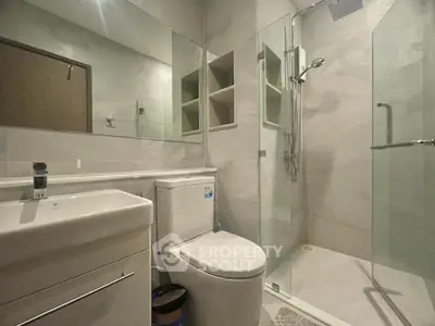 Modern bathroom with glass shower and sleek fixtures