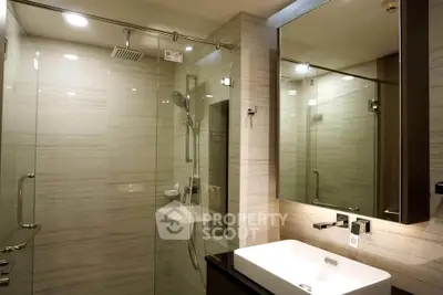 Luxurious modern bathroom with glass shower and elegant fixtures
