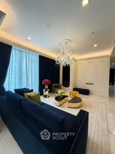 Luxurious living room with elegant chandelier and plush seating in a sophisticated interior design.