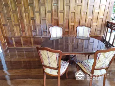 Elegant wooden dining area with vintage chairs and polished floor