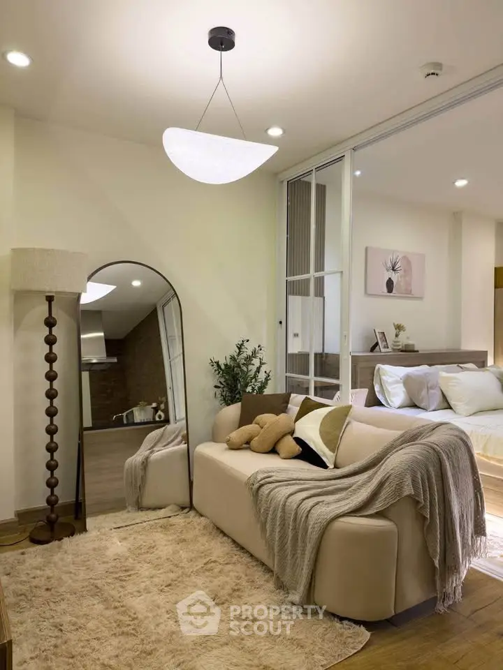 Stylish living room with cozy beige sofa, plush rug, and elegant decor in modern apartment.