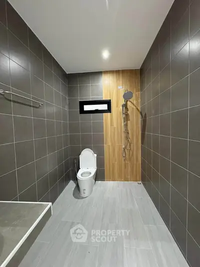 Modern minimalist bathroom with sleek tiles and walk-in shower