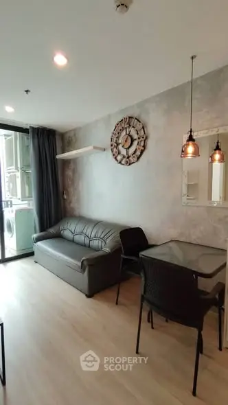 Modern living room with stylish decor and balcony access in a contemporary apartment.
