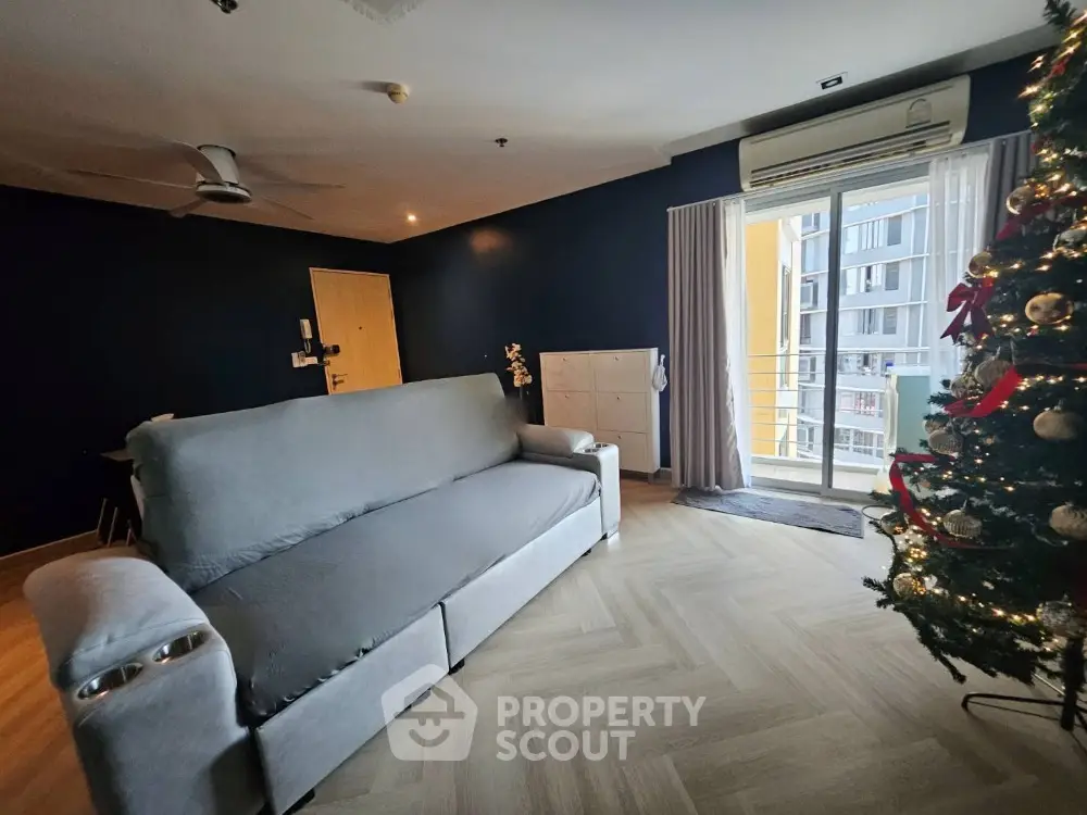 Spacious living room with modern decor and balcony access