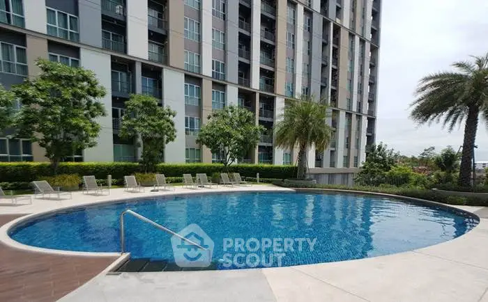 Luxurious apartment complex with a stunning outdoor pool and lush greenery.