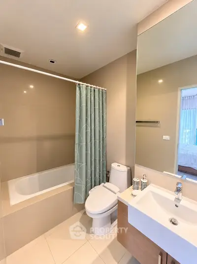 Modern bathroom with bathtub and sleek fixtures in a contemporary apartment.