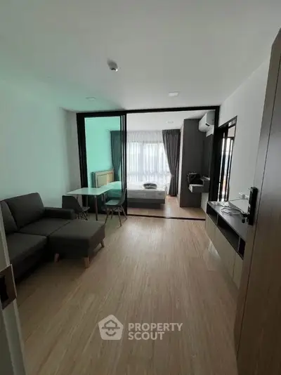 Modern open-plan living room with sleek furniture and natural light