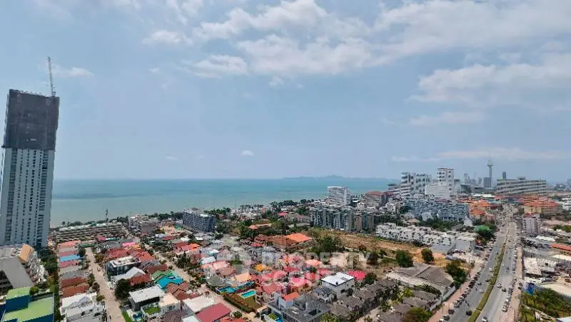Stunning coastal cityscape with ocean view and modern high-rise buildings.