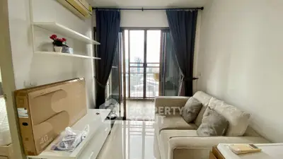 Cozy living room with modern decor and city view balcony access.