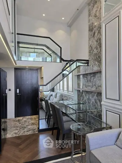 Luxurious modern duplex with elegant staircase and stylish glass dining area