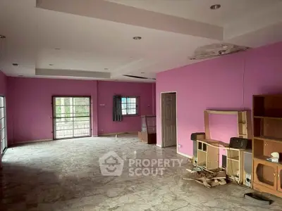 Spacious living room with marble flooring and vibrant pink walls, ideal for modern interior design.