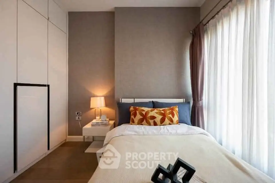 Cozy modern bedroom with stylish decor and natural light