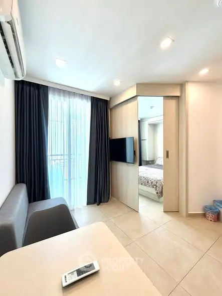 Modern apartment interior with sliding door and natural light