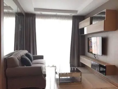 Modern living room with sleek furniture and large windows for natural light.