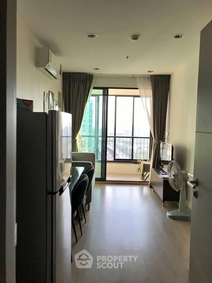 Modern apartment interior with open layout and city view from balcony.