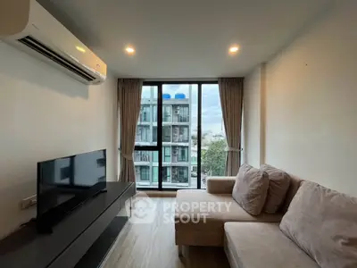 Modern living room with large window and cozy sofa in urban apartment