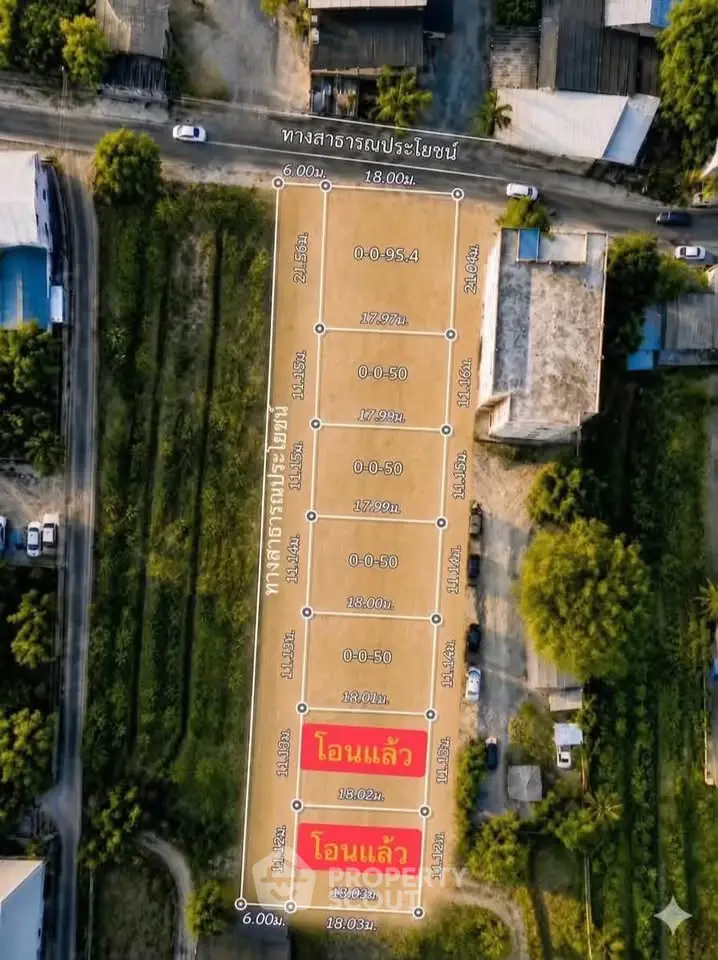 Aerial view of a plotted land with dimensions marked, ideal for development.