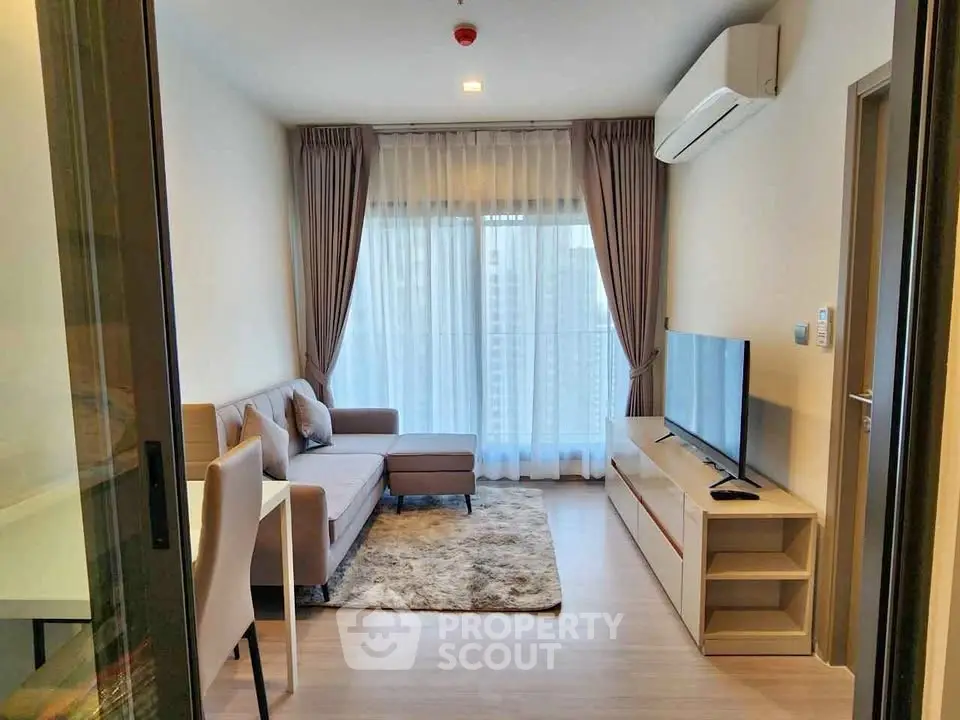 Modern living room with cozy sofa, large TV, and elegant curtains in a stylish apartment.