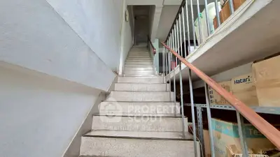 Spacious stairway in a residential building with storage area, ideal for easy access and organization.