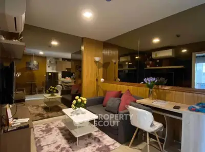 Modern living room with cozy sofa, stylish decor, and open kitchen layout