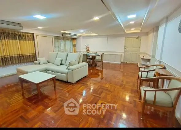 Spacious living room with elegant wooden flooring and modern furniture