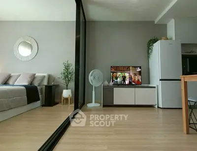 Modern open-plan living room with sleek decor and natural light