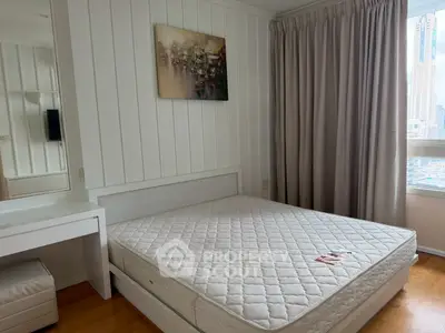 Spacious bedroom with large window and modern decor in urban apartment