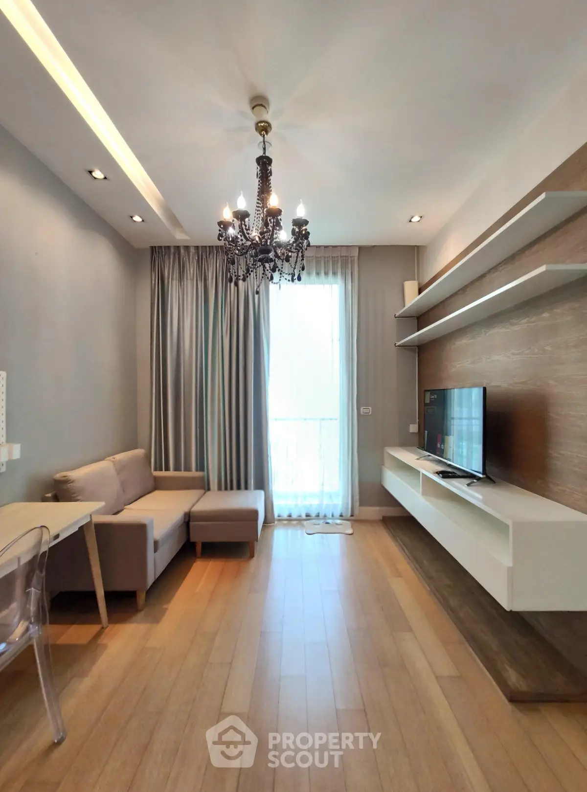 Modern living room with elegant chandelier and stylish decor