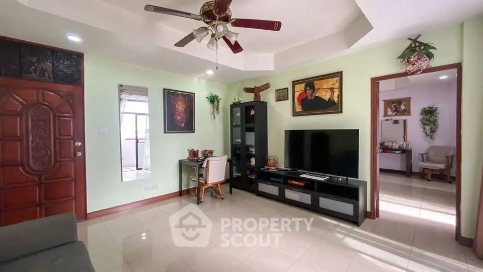 Spacious living room with modern decor and large TV unit