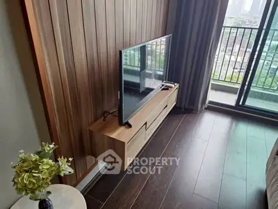 Modern living room with sleek TV stand and balcony view