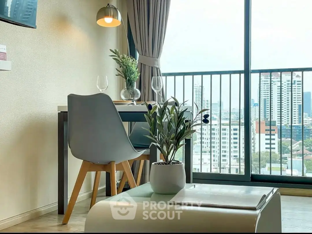 Chic urban apartment with stunning city view from cozy dining area.