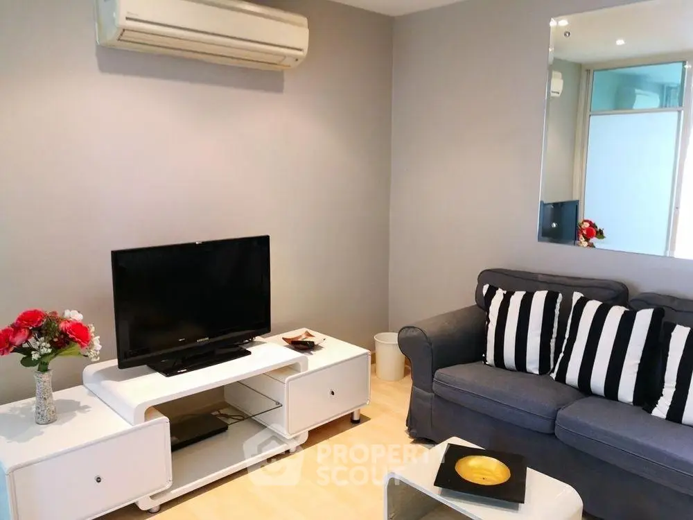 Modern living room with sleek furniture and air conditioning, perfect for comfortable living.
