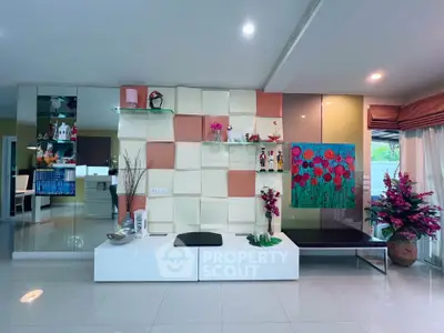 Modern living room with stylish decor and vibrant artwork